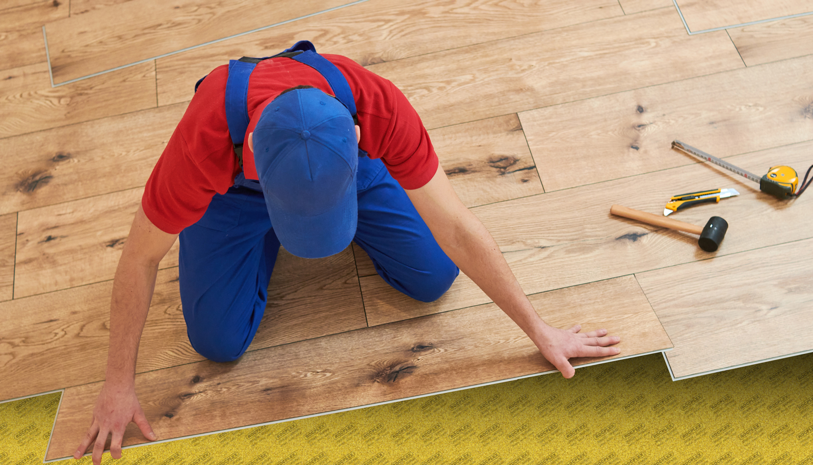 vinyl floor installation. Close-up hands of worker at home flooring renovation.; Shutterstock ID 2238903849; other: -; purchase_order: -; client: -; job: -